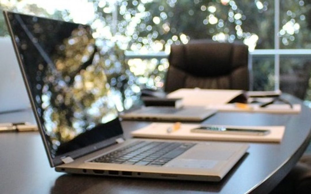 Laptop in boardroom running automatic PowerPoint presentation.