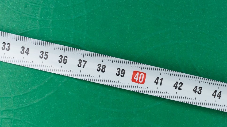 Convert cm to inches in Excel represented by a measuring tape.